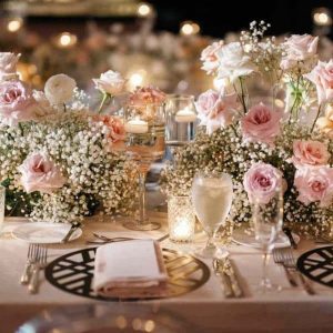 Floral candle light dinner setup with fresh flowers, elegant table décor, candles, and soft romantic lighting