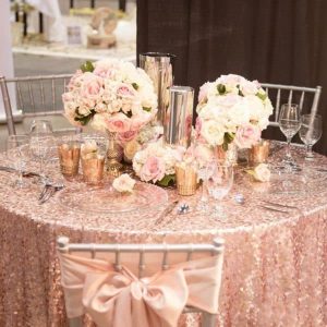 Pink blush candle light dinner decoration with soft pink décor, candles, floral accents, and warm romantic lighting
