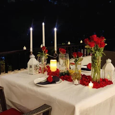 19 Simple candle light dinner setup at home with candles, rose petals, and elegant table decor for a romantic evening