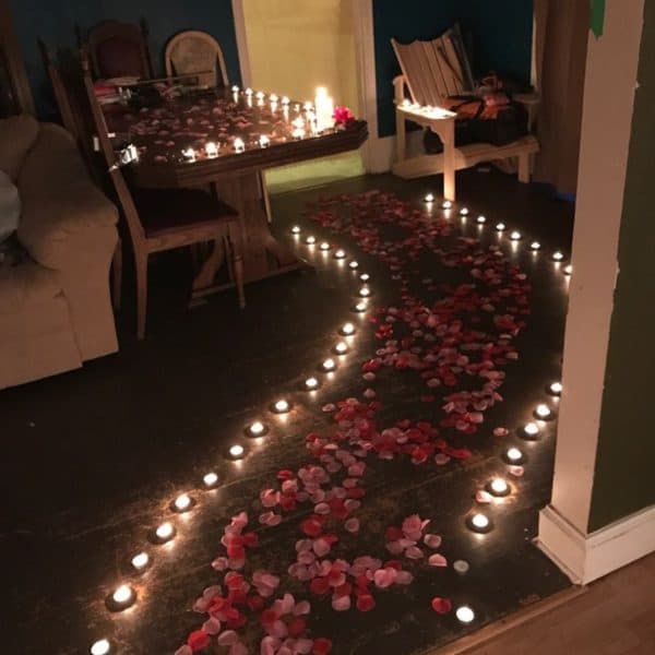Simple candle light dinner setup at home with candles, rose petals, and elegant table decor for a romantic evening 2