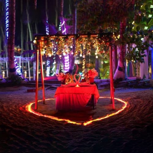 29 Simple candle light dinner setup at home with candles, rose petals, and elegant table decor for a romantic evening